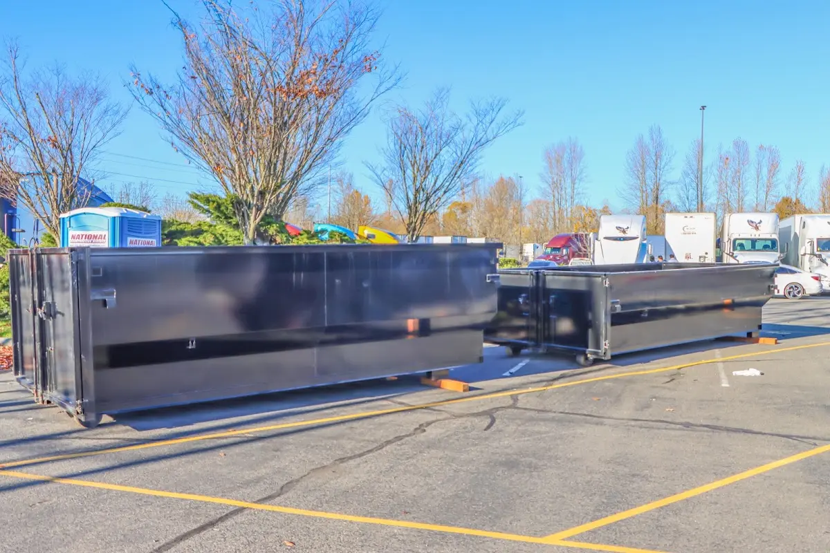 Professional dumpster rental service with roll-off container on residential driveway in Greenwood Village